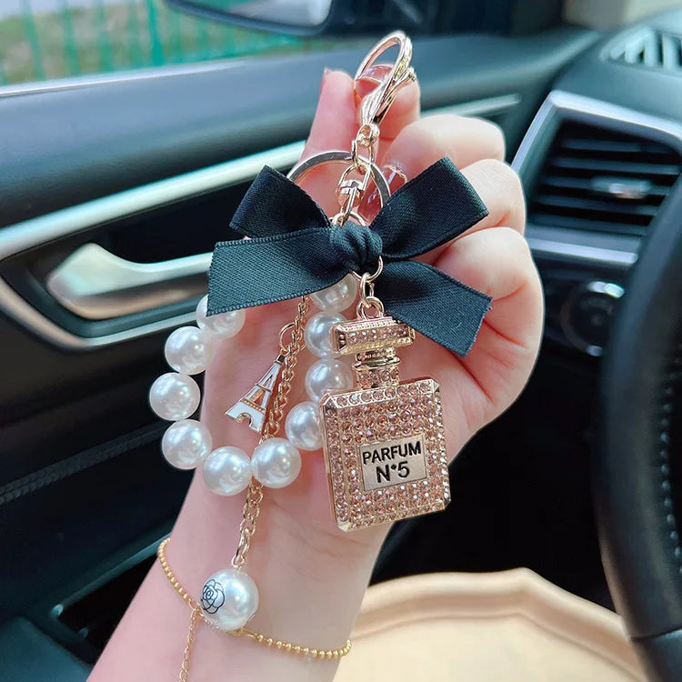Alloy diamond inlaid bow shaped perfume bottle key chain creative pearl chain bag pendant exquisite key chain