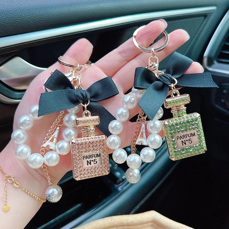 Alloy diamond inlaid bow shaped perfume bottle key chain creative pearl chain bag pendant exquisite key chain