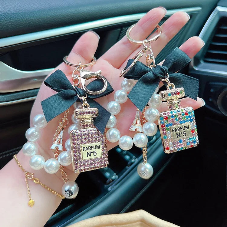 Alloy diamond inlaid bow shaped perfume bottle key chain creative pearl chain bag pendant exquisite key chain