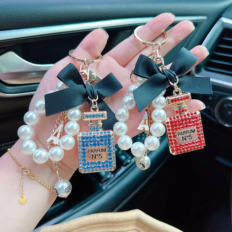 Alloy diamond inlaid bow shaped perfume bottle key chain creative pearl chain bag pendant exquisite key chain
