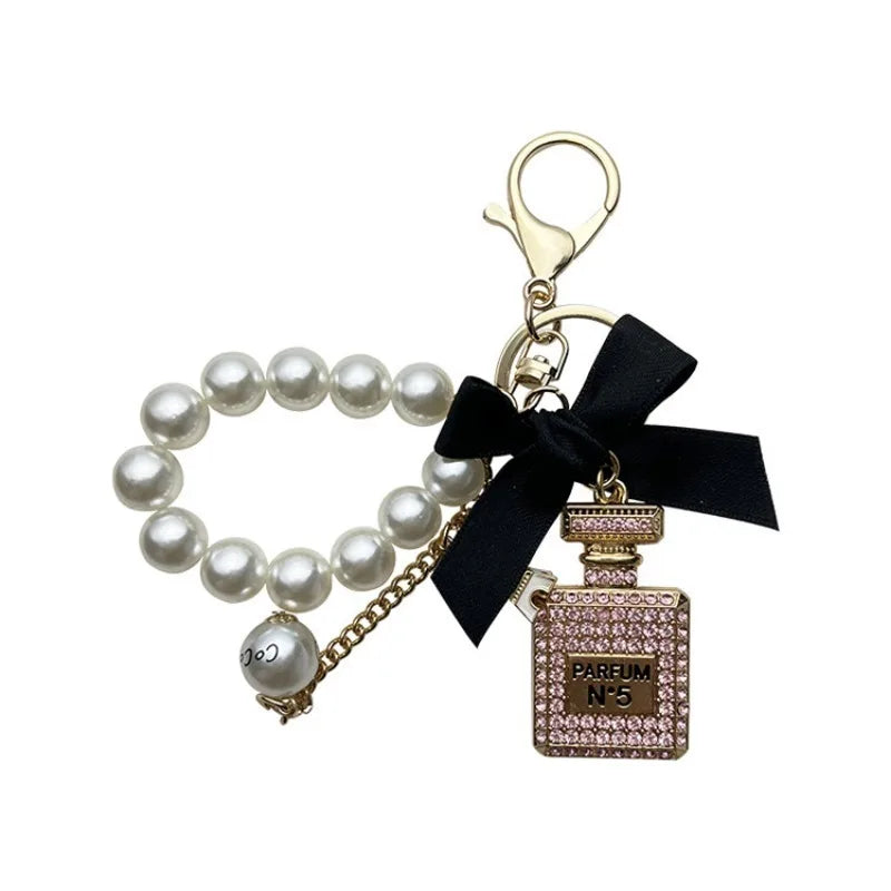 Alloy diamond inlaid bow shaped perfume bottle key chain creative pearl chain bag pendant exquisite key chain