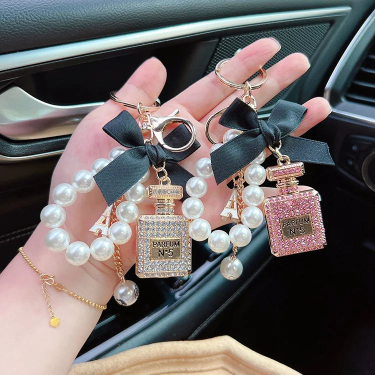 Alloy diamond inlaid bow shaped perfume bottle key chain creative pearl chain bag pendant exquisite key chain