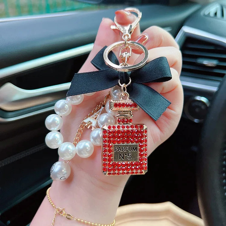 Alloy diamond inlaid bow shaped perfume bottle key chain creative pearl chain bag pendant exquisite key chain