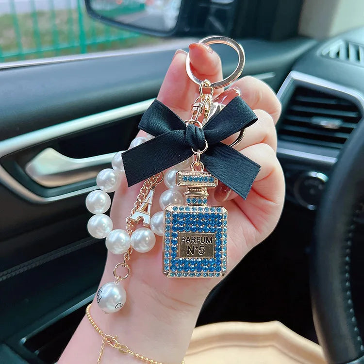 Alloy diamond inlaid bow shaped perfume bottle key chain creative pearl chain bag pendant exquisite key chain
